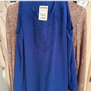 Blue cold shoulder top with embroidered design.